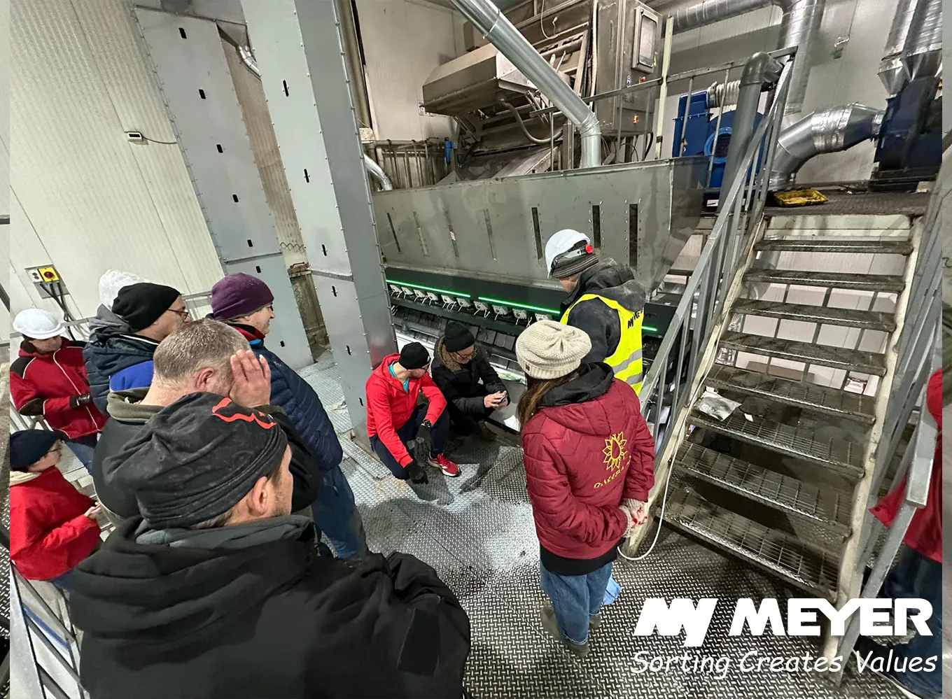 MEYER installation visit with customers observing an optical sorting system during operation at a processing facility.
